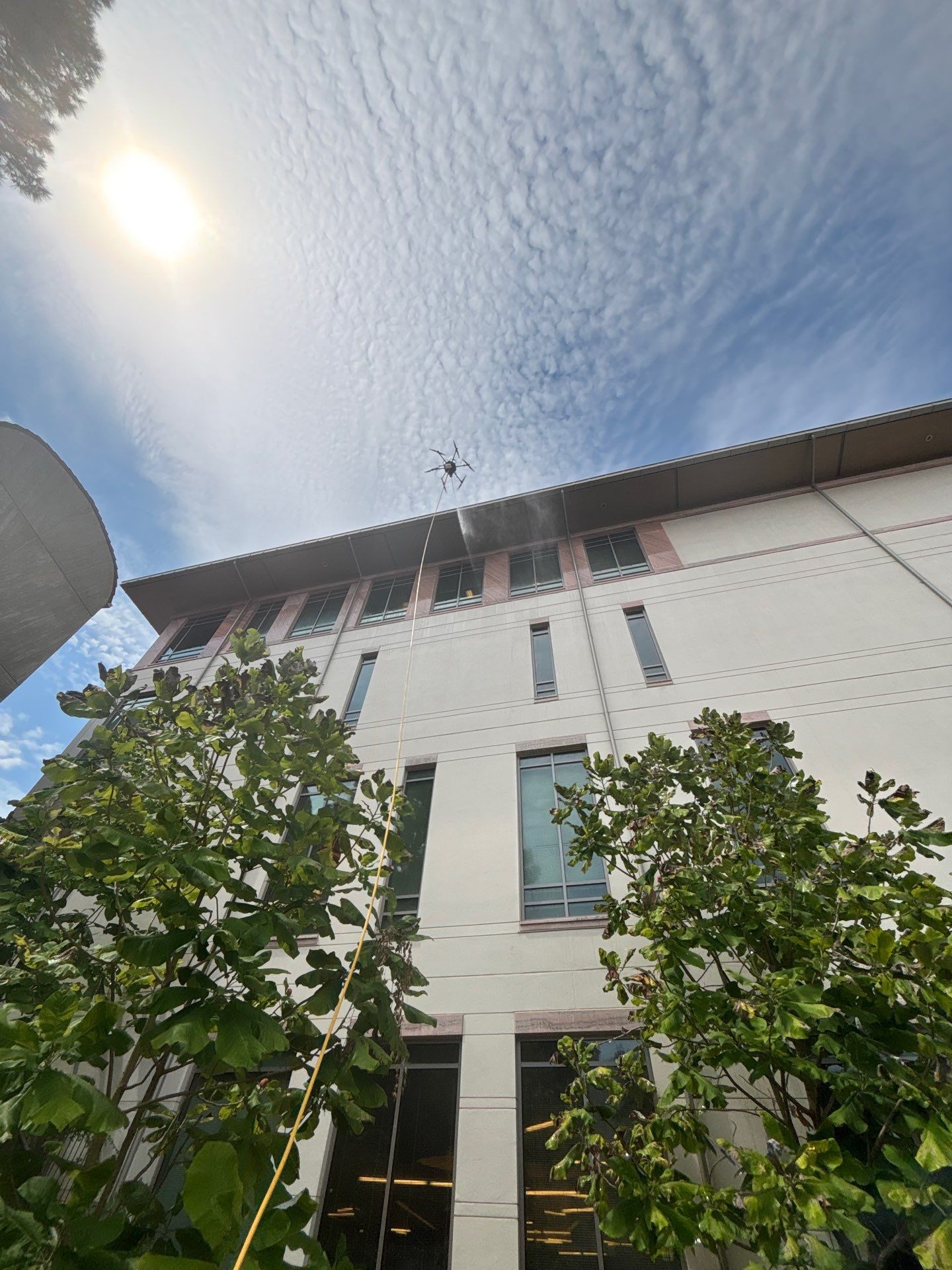 Drone cleaning a commercial building exterior